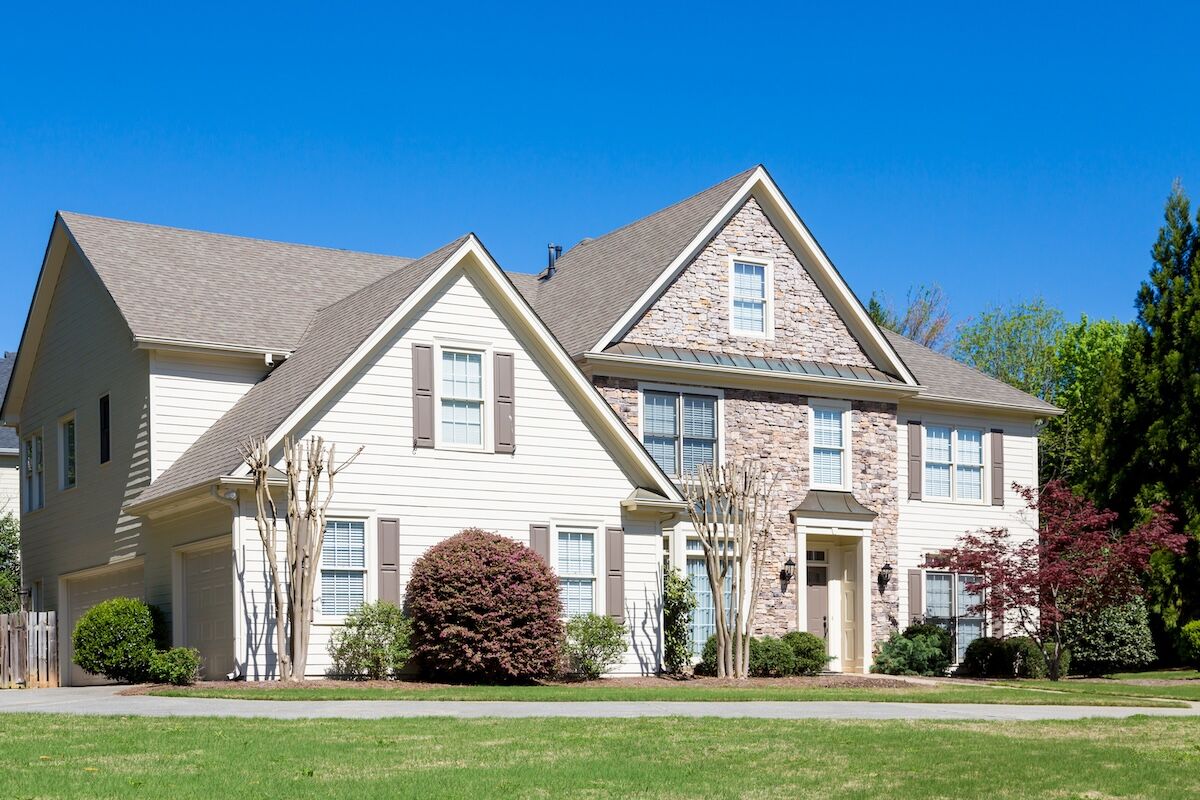 stone and vinyl siding combination on suburban home
