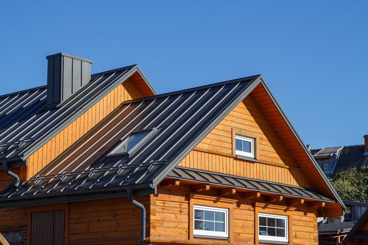 Wooden cabin with a black metal roof