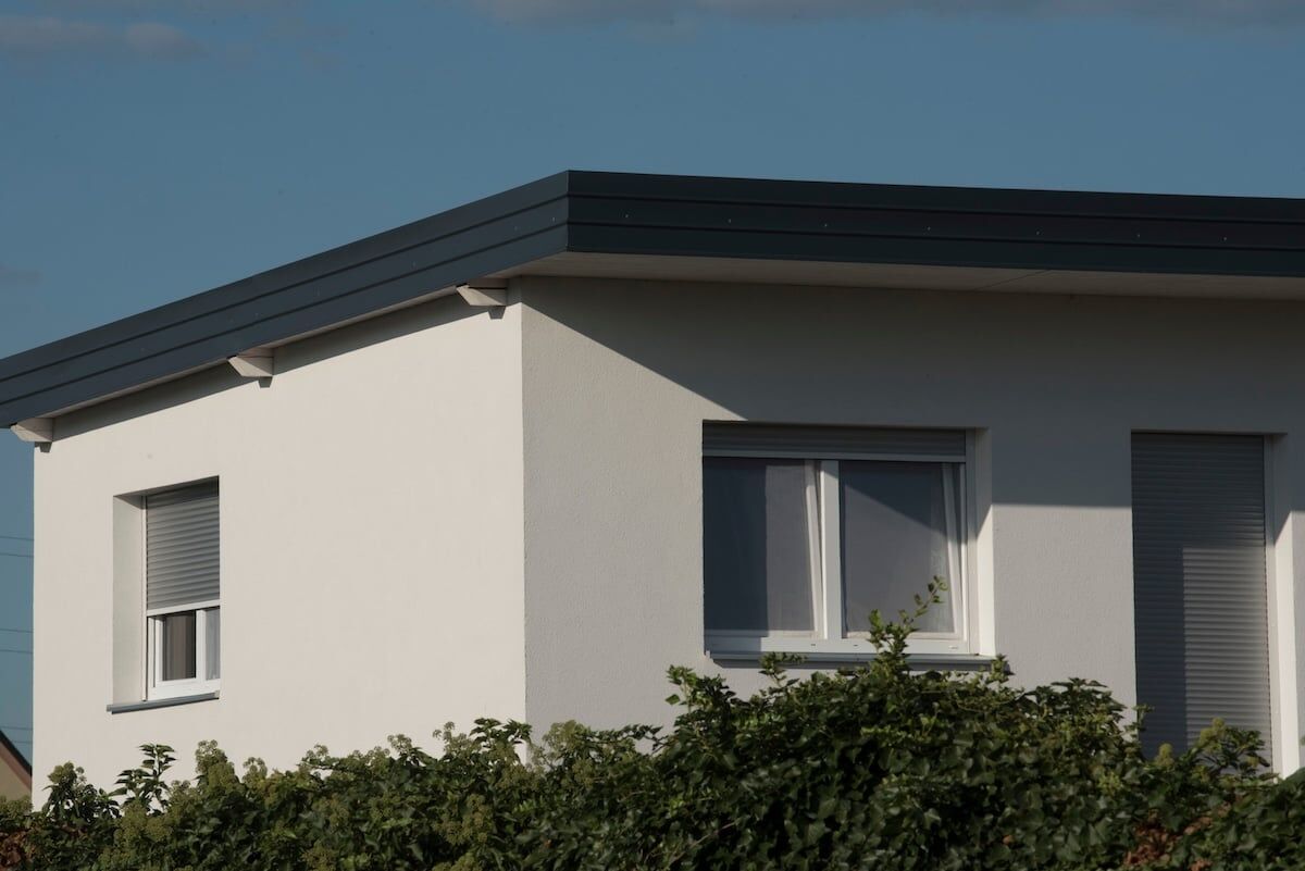 Modern white house with simple black flat roof