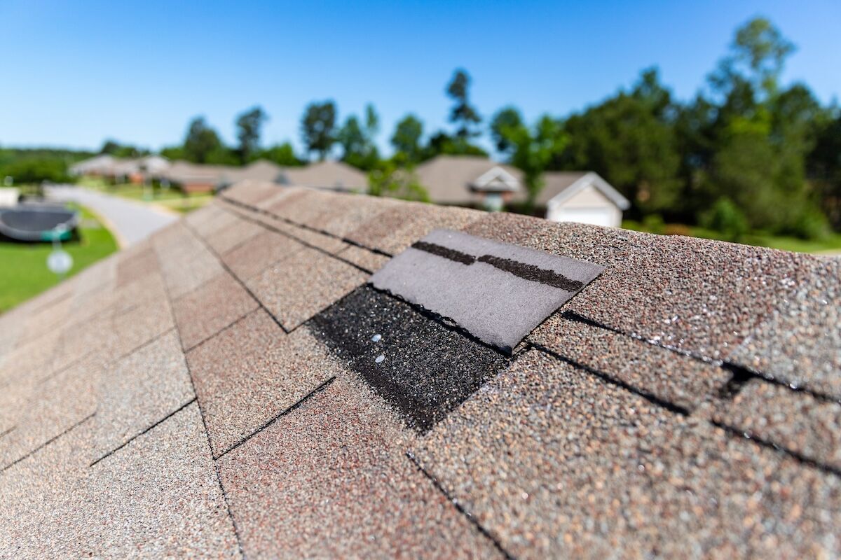 Missing shingles on roof due to wind damage.