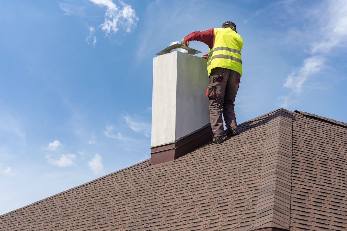 Chimney repairs on roof of home