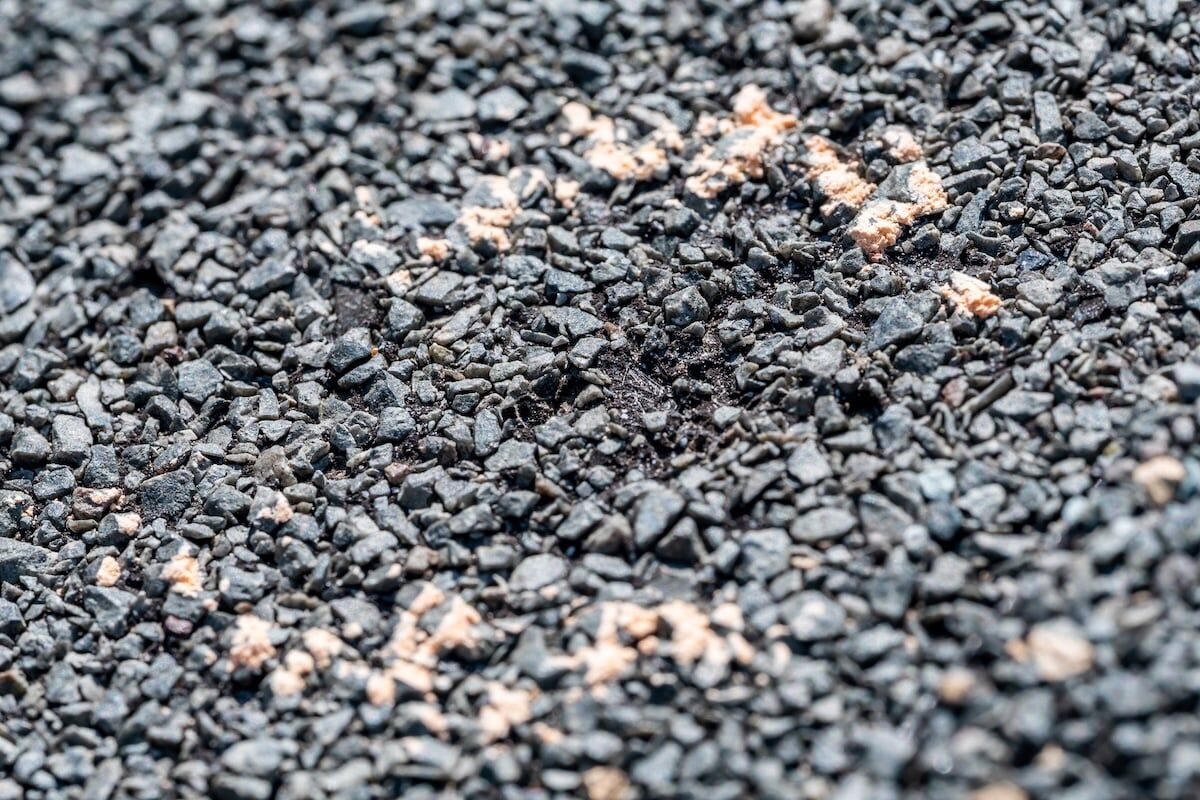 Macro of hail damage on a shingle residential roof circled with a chalk outline during a home inspection