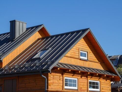 Wooden natural siding with dark black metal roof