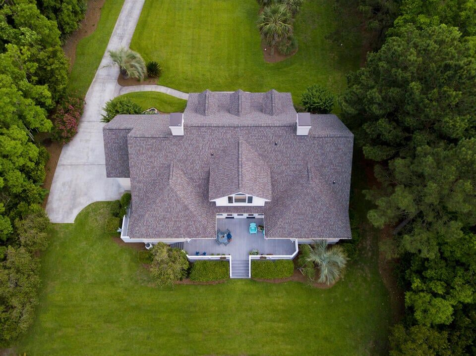 does a new roof increase home value-aerial view of a large residential home with a new shingle roof