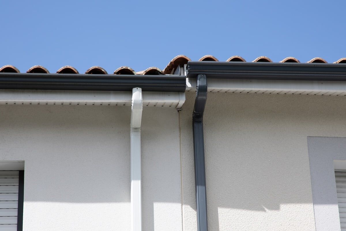 grey white edge of roof gutters of semi-detached houses aluminum gutter guard system of shingles