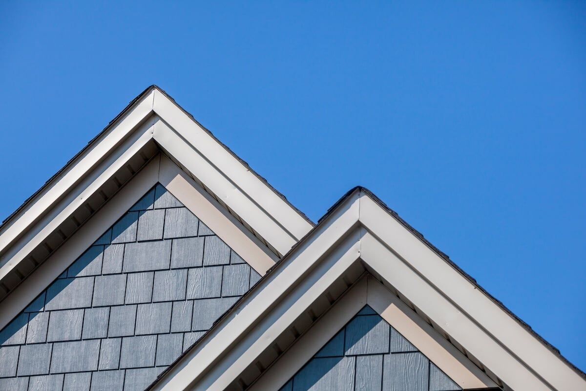 New roof installed on house, blue siding