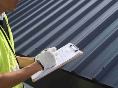 roofer inspecting house
