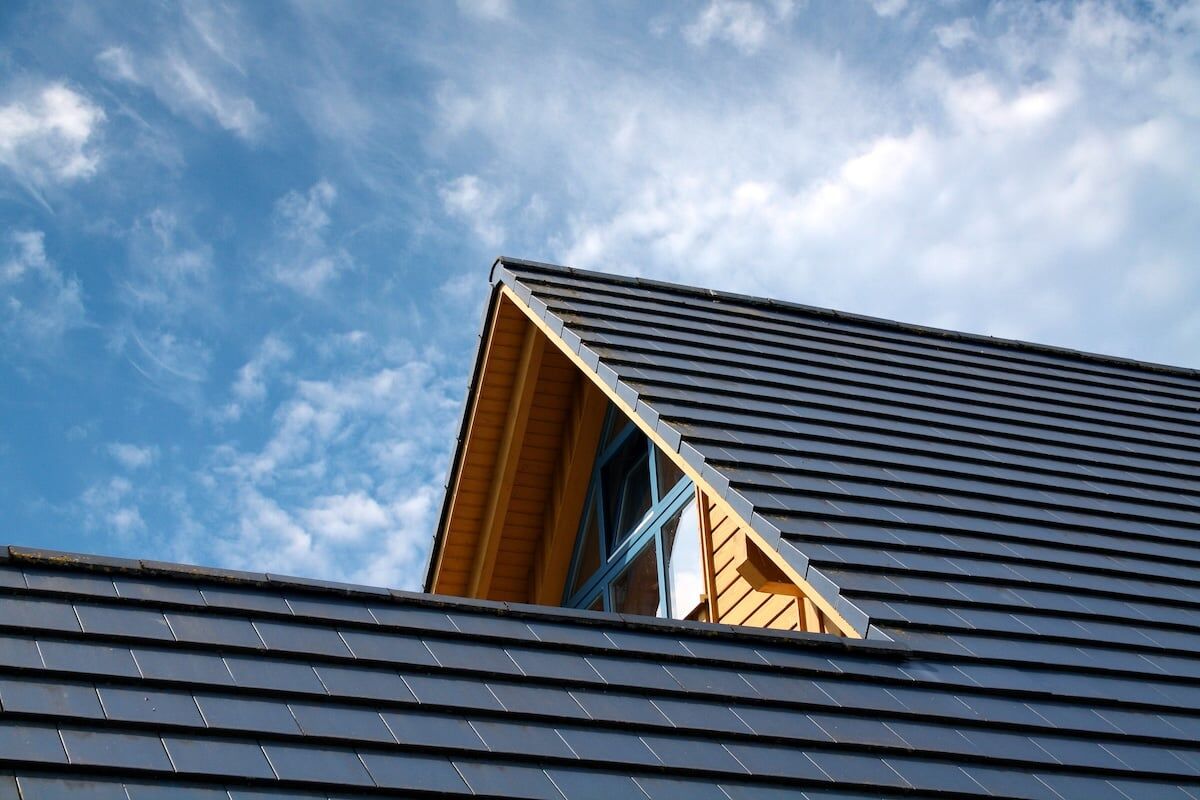 Black metal roof on brown house modern