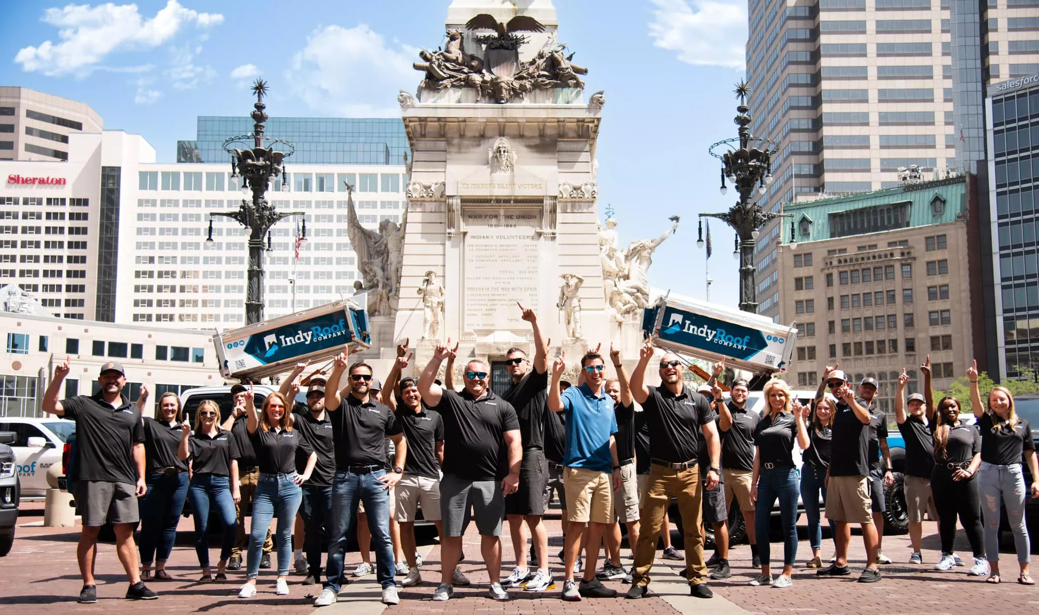 team photo of indy roof and restoration employees in Indianapolis skyline