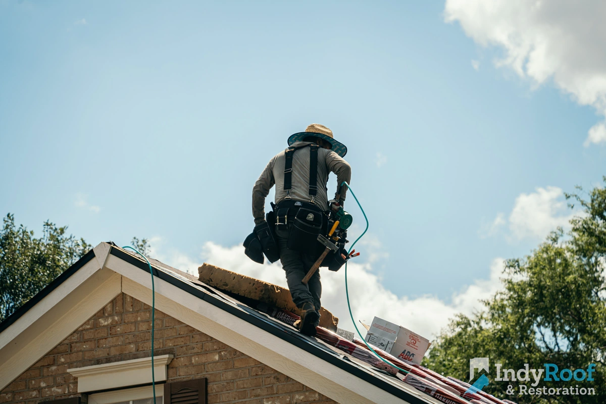 Indy Roof & Restoration worker standing on a roof