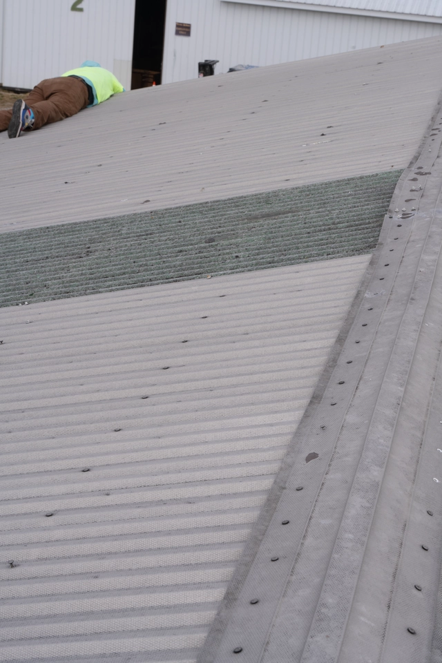 roofer on metal roof