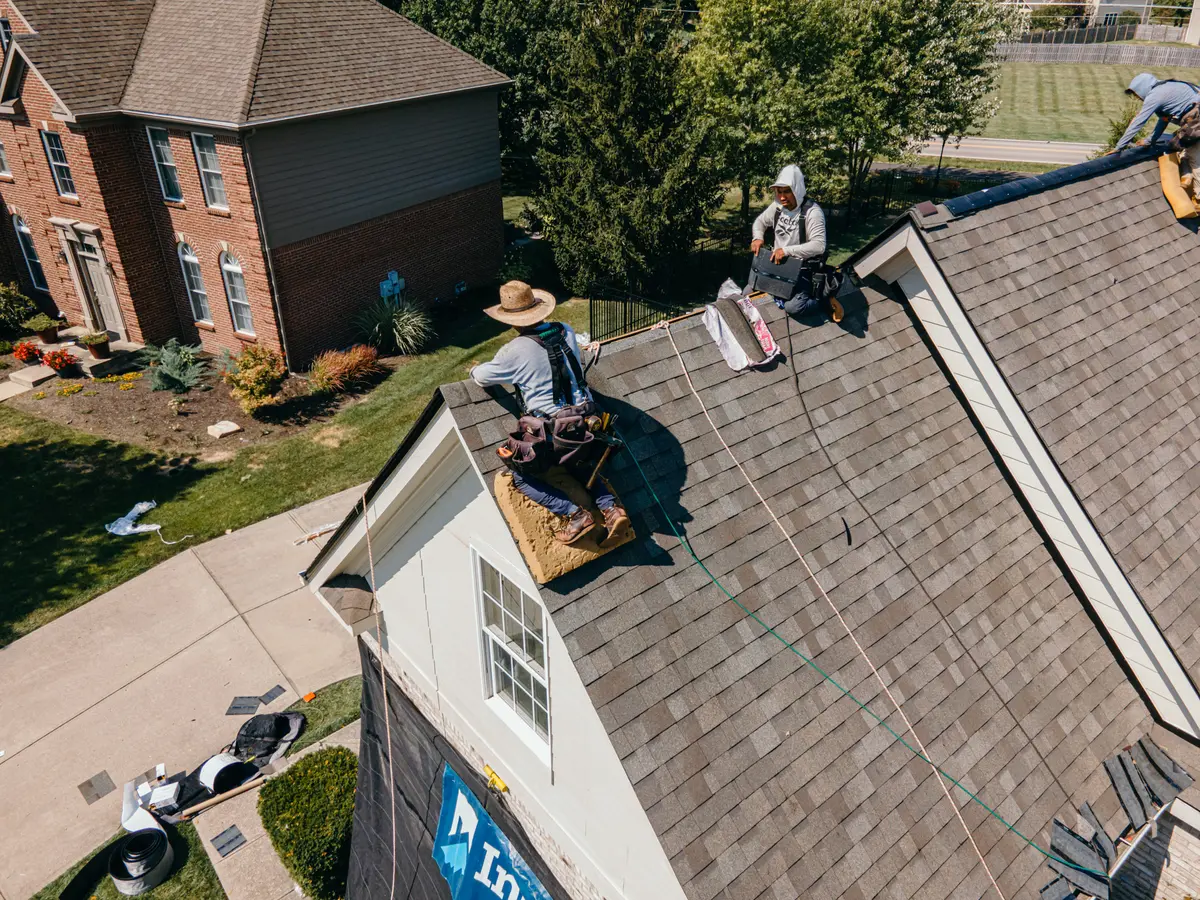 roofer on top of eaves