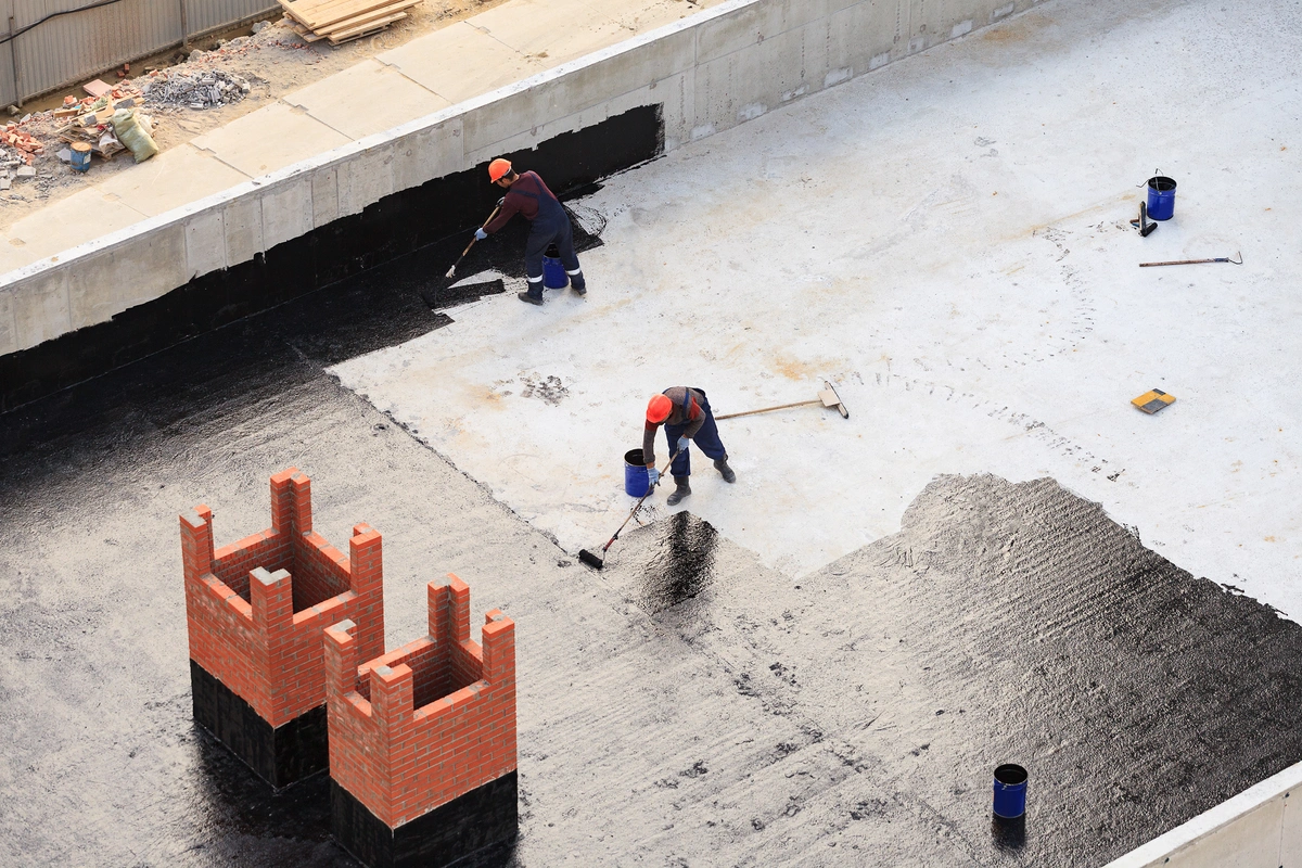 roofers applying a coating